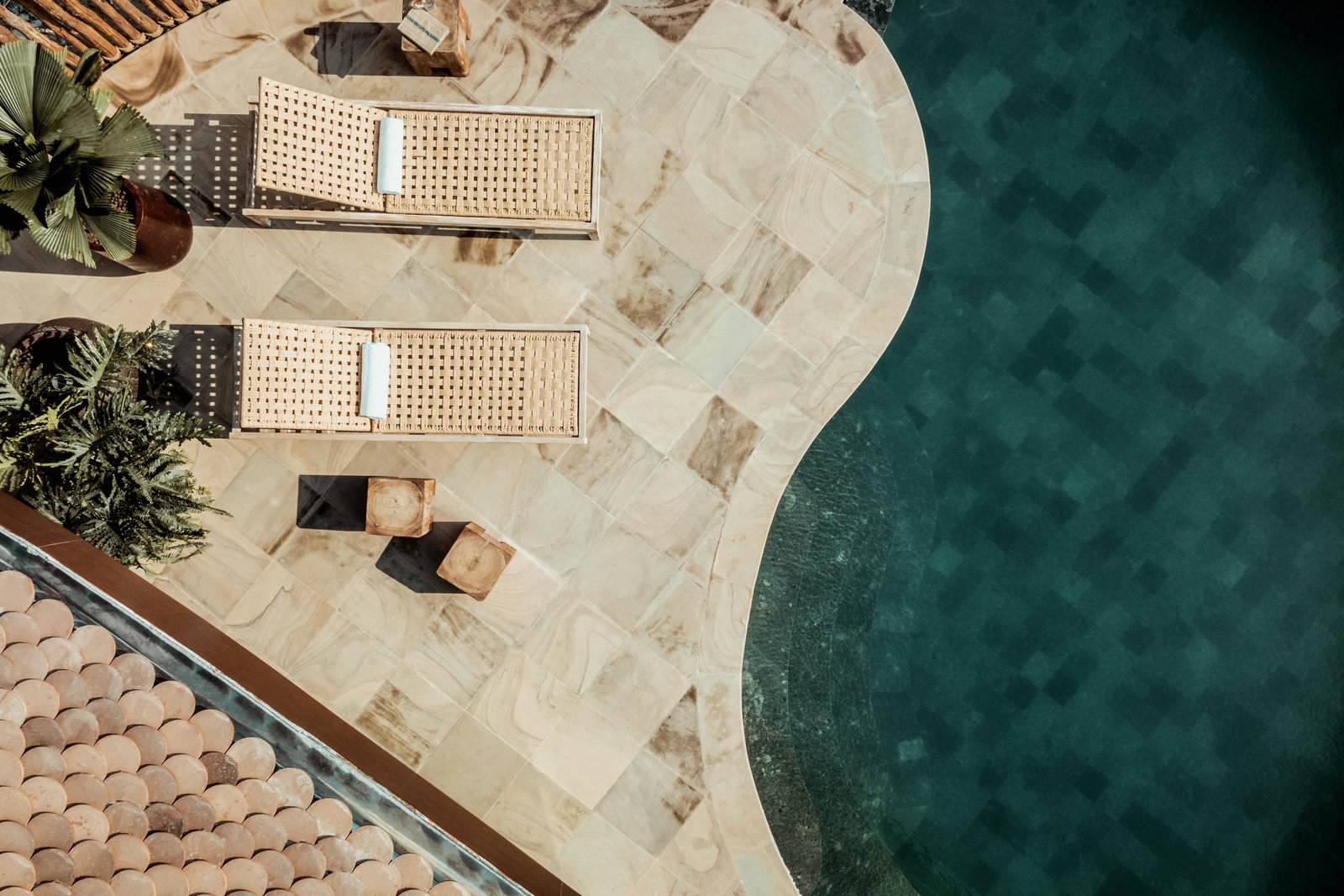 Aerial view of thatched-roof villas amongst lush greenery on a river island, Namia River Retreat in Hoi An